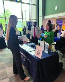 Two women and one man in conversation at a table during the career fair Accounting and Finance Students Connect with Industry Professionals thumbnail