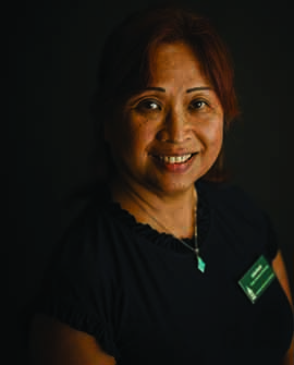 Headshot of Dr. Kwok in dark shirt on a dark background